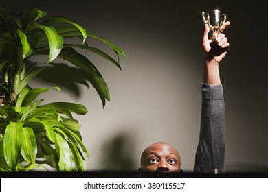 Businessman Holding Up His Trophy