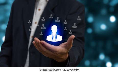 Businessman Holding HRM Or Human Resource Management, Cons For Human Development Recruitment Leadership And Customer Target. Organization Structure Concept.