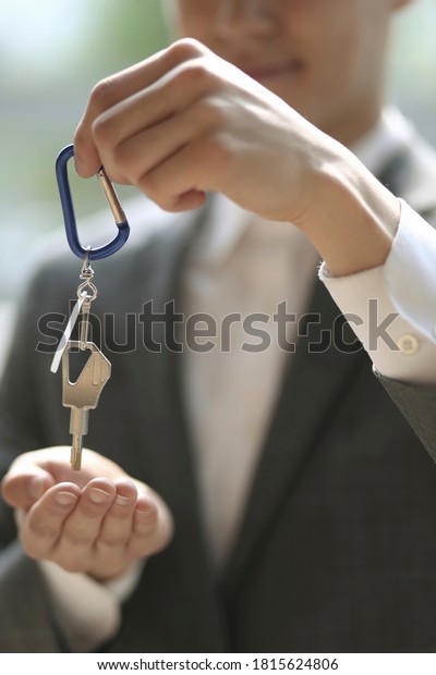 Businessman holding key ring\
and key  \
