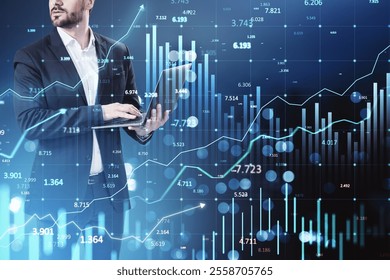 Businessman holding laptop, financial data graphs and charts overlayed, blue background, concept of stock market and global trading - Powered by Shutterstock - Get 15% off with code: PIKWIZARD15