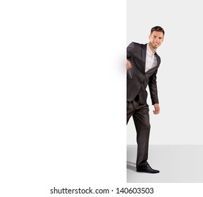 Businessman holding a large blank paper - Shutterstock ID 140603503