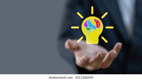 Businessman holding light bulb, colorful human brain smart thinking brainstorming creative idea,creative intelligence mind,education knowledge study and learn,science and innovation - Shutterstock ID 2311266545