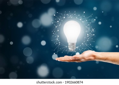 Businessman holding light bulb. Idea concept - Shutterstock ID 1902660874