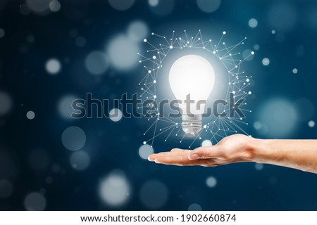 Businessman holding light bulb. Idea concept