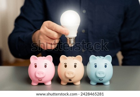 Businessman holding a light bulb over a piggy bank. Choose the best investment idea. New ways to save money. Invest. Open a deposit. Invest in business. Ingenuity and creativity. Eureka moment