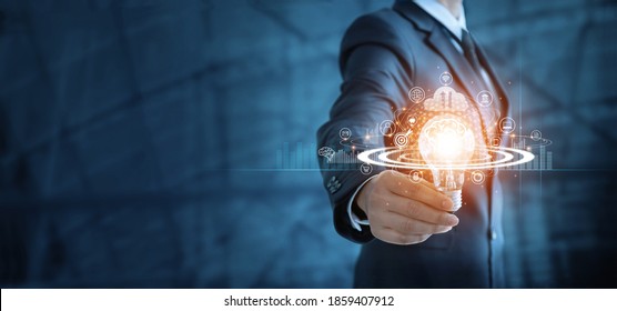 Businessman holding lightbulb and brain with network of business,  Modern executive management’s positive attitude, Growth mindset and developed new era in organization. - Shutterstock ID 1859407912
