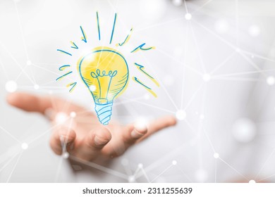 A businessman holding a lightbulb icon on a phone- idea and innovation concept - Powered by Shutterstock