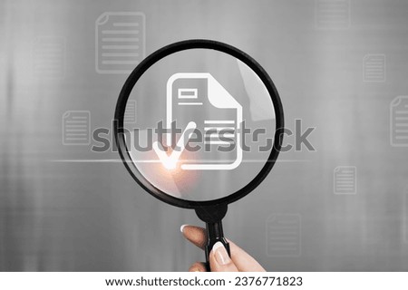 Businessman holding magnifying glass with document icon