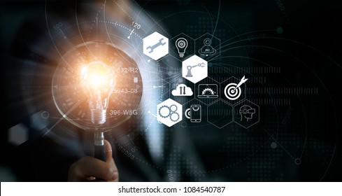 
Businessman holding magnifying glass and light bulb. Idea and imagination. Creative and inspiration. Innovation icon network connection. Search engine optimization. Innovative technology industrial