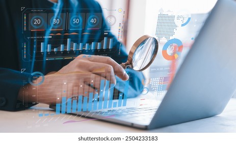 businessman holding magnifying glass looking at virtual data chart dashboard in concept of investment data analysis and DMS document audit financial Tax Fraud audit Using Magnifying Glass - Powered by Shutterstock