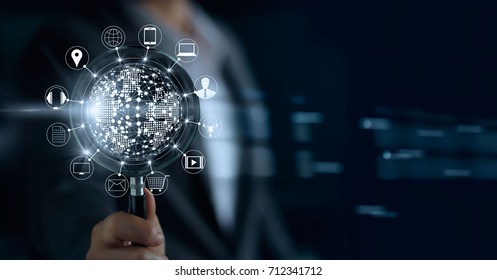 Businessman holding magnifying glass, search payments online shopping and icon customer network connection on screen, m-banking and omni channel 
