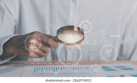 Businessman holding a magnifying glass,Audit Document Concepts, quality assessment management With a checklist, business document evaluation process, market data report analysis and consulting