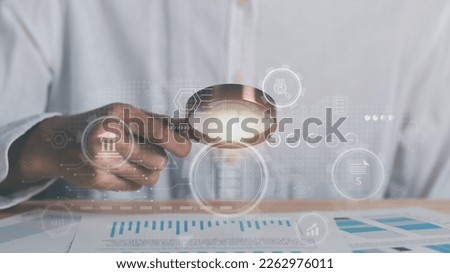 Businessman holding a magnifying glass,Audit Document Concepts, quality assessment management With a checklist, business document evaluation process, market data report analysis and consulting