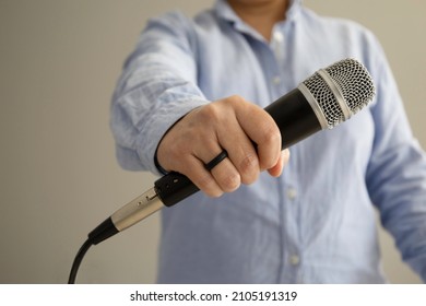 Businessman Holding Microphone, Front View
