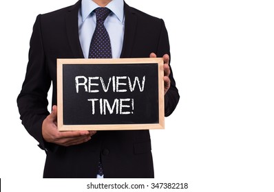 Businessman holding mini blackboard with REVIEW TIME! message