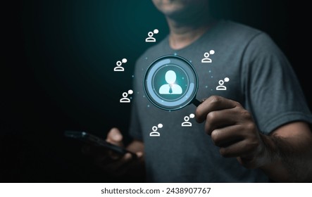 Businessman holding mobile phone and magnifying glass, looking screen with a person in the center. Concept Human resource of searching for employee, possibly a friend or a piece of information - Powered by Shutterstock