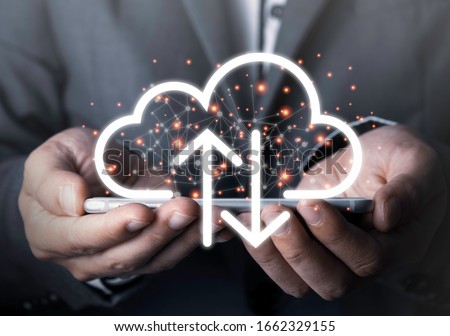 Businessman holding mobile phone which on the top of phone has upload and download cloud space computer.Technology and data information transfer concept.