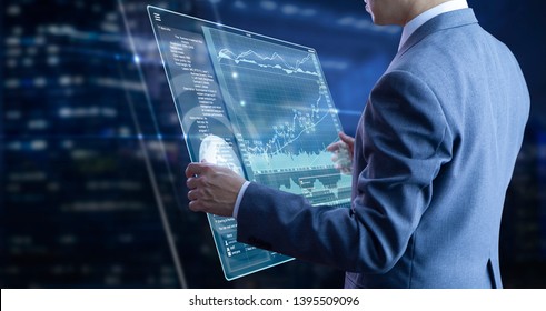 Businessman holding a modern tablet touch screen analysing on investment risk managment and return on investment analysis - Powered by Shutterstock