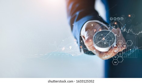Businessman holding a navigation compass in hand and define marketing direction and analysis growth sale data with search customer global network, Abstract business.  - Shutterstock ID 1633125352