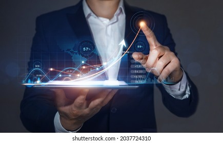 Businessman holding on tablet and draws arrow growth graph of business. Business strategy development  and growing growth plan.  Global business investment