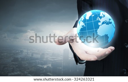 Businessman holding in palm digital Earth planet