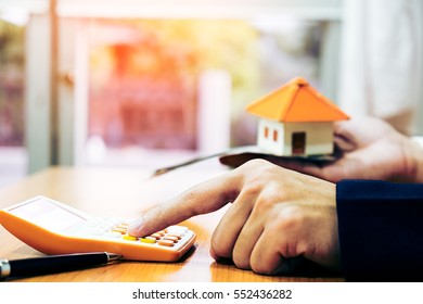 Businessman Holding Paper Home Model. Loan Concept
