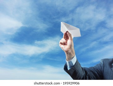 Businessman Holding Paper Plane In His Hand