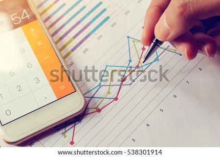 Businessman holding pen and think with cost with calculator in smartphone.