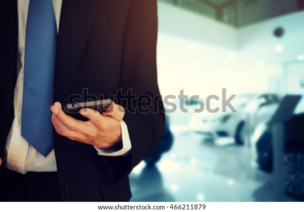 Businessman holding\
phone