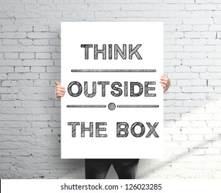 Businessman Holding Poster With Think Outside The Box