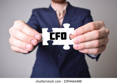 Businessman holding a puzzle with the inscription:CFO