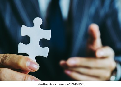 businessman holding a Puzzle piece