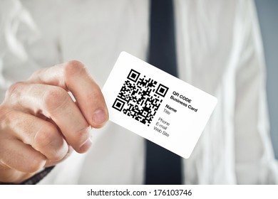 Businessman Holding QR Code Business Card With Personal Data. Modern Technology Concept.