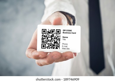 Businessman Holding QR Code Business Card With Personal Data. Modern Technology Concept.