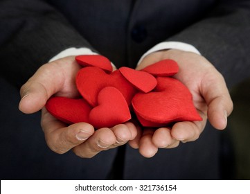 Businessman Holding Red Hearts - Customer Relationship Management Concept