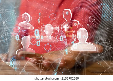 A businessman holding a render of a network of profile icons and binary code