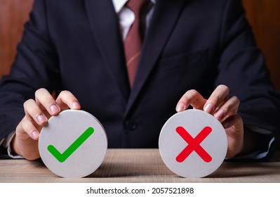 Businessman holding right and wrong icon. Idea for about choices the good or bad way for business.