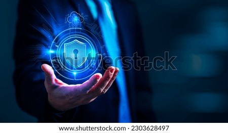 Businessman holding a shield protect icon, symbolizing the need for robust network security and data protection measures, Protecting your business from cyber threats Concept