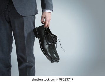 Businessman Holding The Shoes In Hand, Close Up