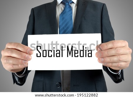 Businessman holding or showing card with social media text