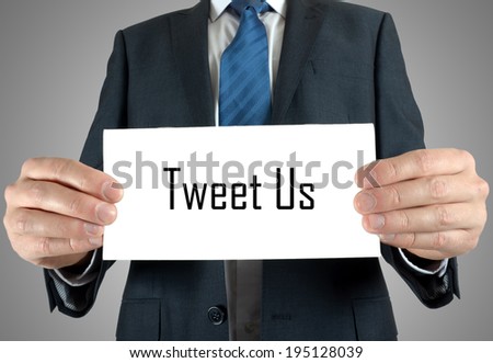 Businessman holding or showing card with tweet us text