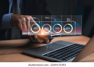 Businessman holding smart phone and showing a growing virtual hologram of statistics, graph and chart with arrow up on the dark background. Stock market. Business growth concept. - Shutterstock ID 2269172393