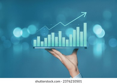 Businessman holding smartphone with business chart growth graph and and increase of chart positive indicators business. Analysis of investment strategies and economic trends.