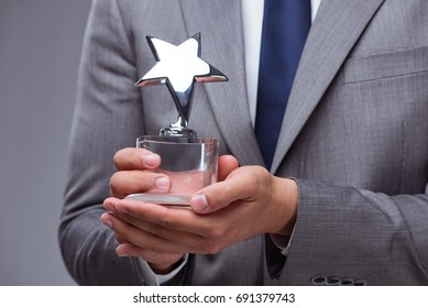 Businessman Holding Star Award In Business Concept