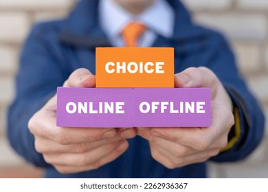 Businessman holding styrofoam blocks with inscription: CHOICE ONLINE OFFLINE. Choose between online and offline in everything.