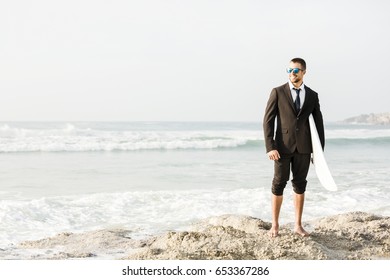 A Businessman holding is surfboard after a long day of work - Powered by Shutterstock