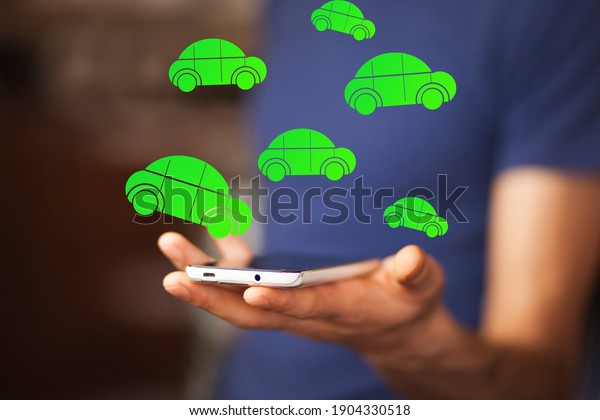 Businessman holding tablet\
with car icons.