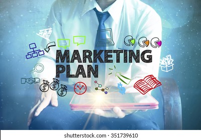 Businessman Holding A Tablet Computer With MARKETING PLAN Text ,business Concept 