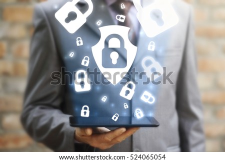 Businessman holding tablet computer with shield lock and cloud lock protection security safety internet business technology concept. Mobile device tablet pc secure access app privacy. Guardian protect