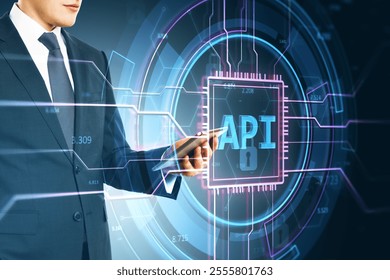 Businessman holding a tablet with neon API interface, futuristic circuit design, blue digital background, concept of tech and software